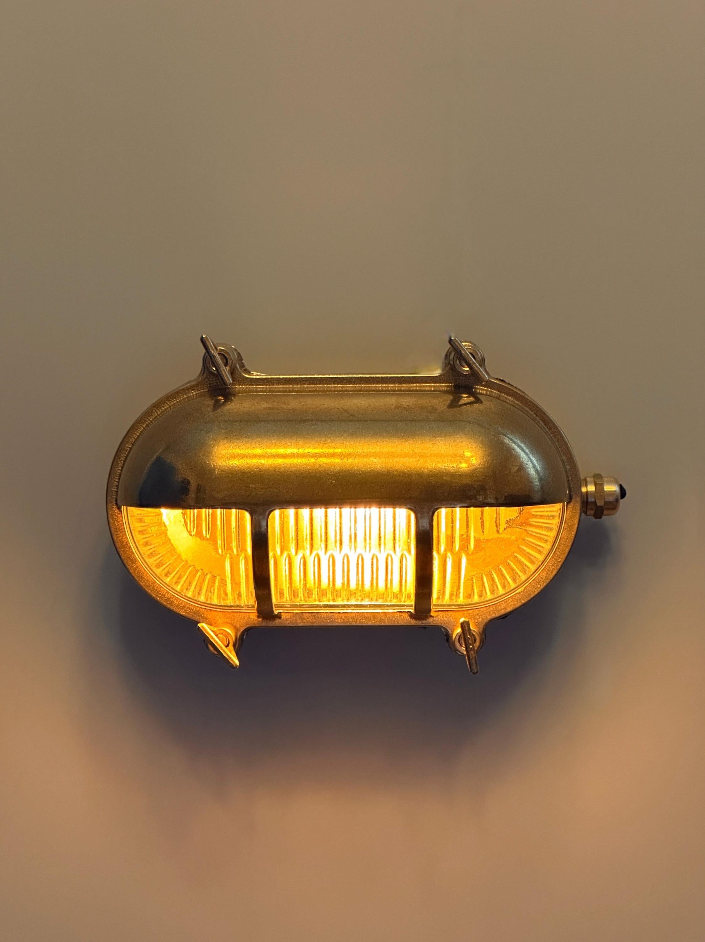 Gnarp Brass Outdoor Wall Sconce – Nautical Bulkhead Light with Ribbed Glass