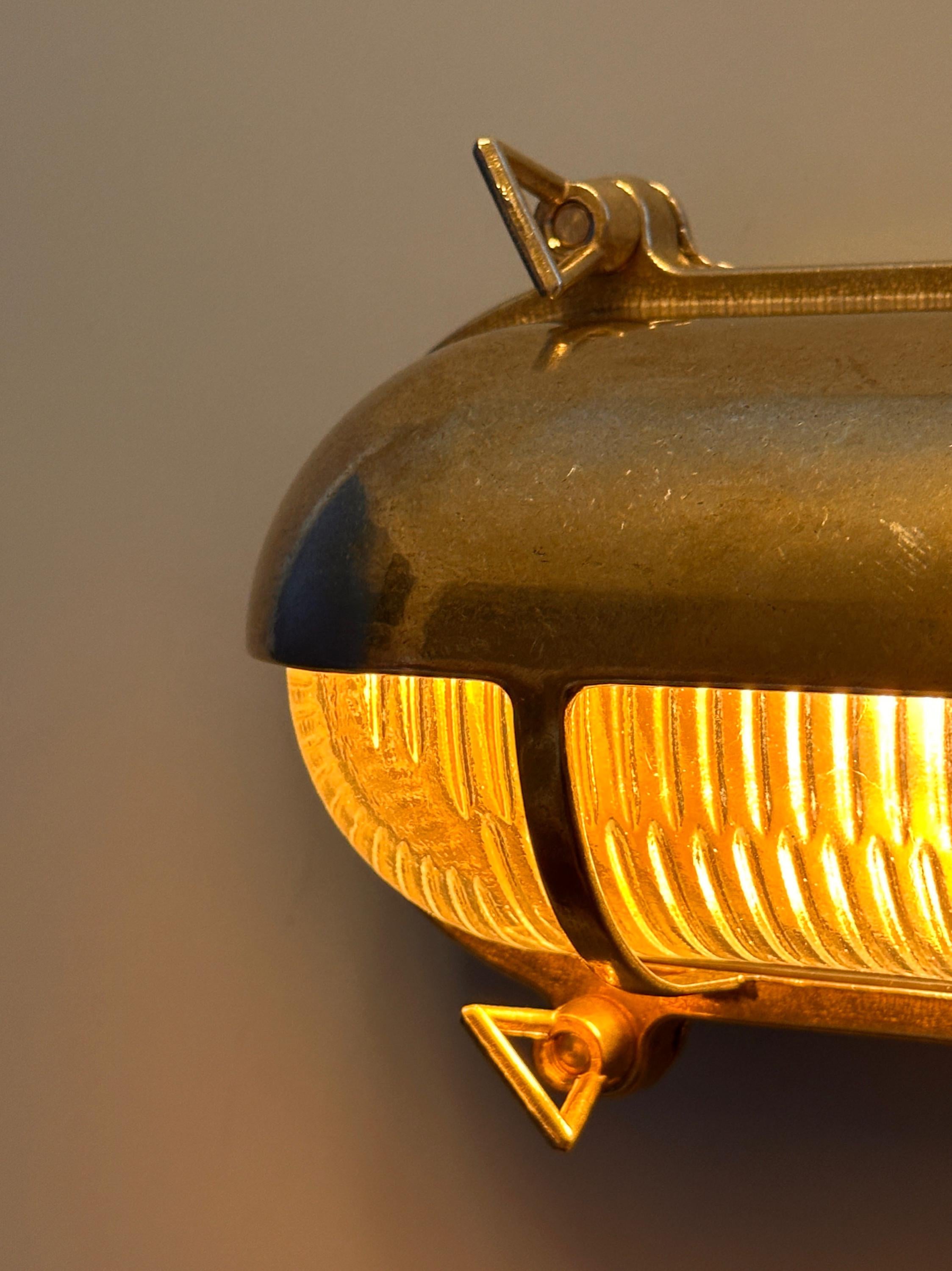 Gnarp Brass Outdoor Wall Sconce – Nautical Bulkhead Light with Ribbed Glass