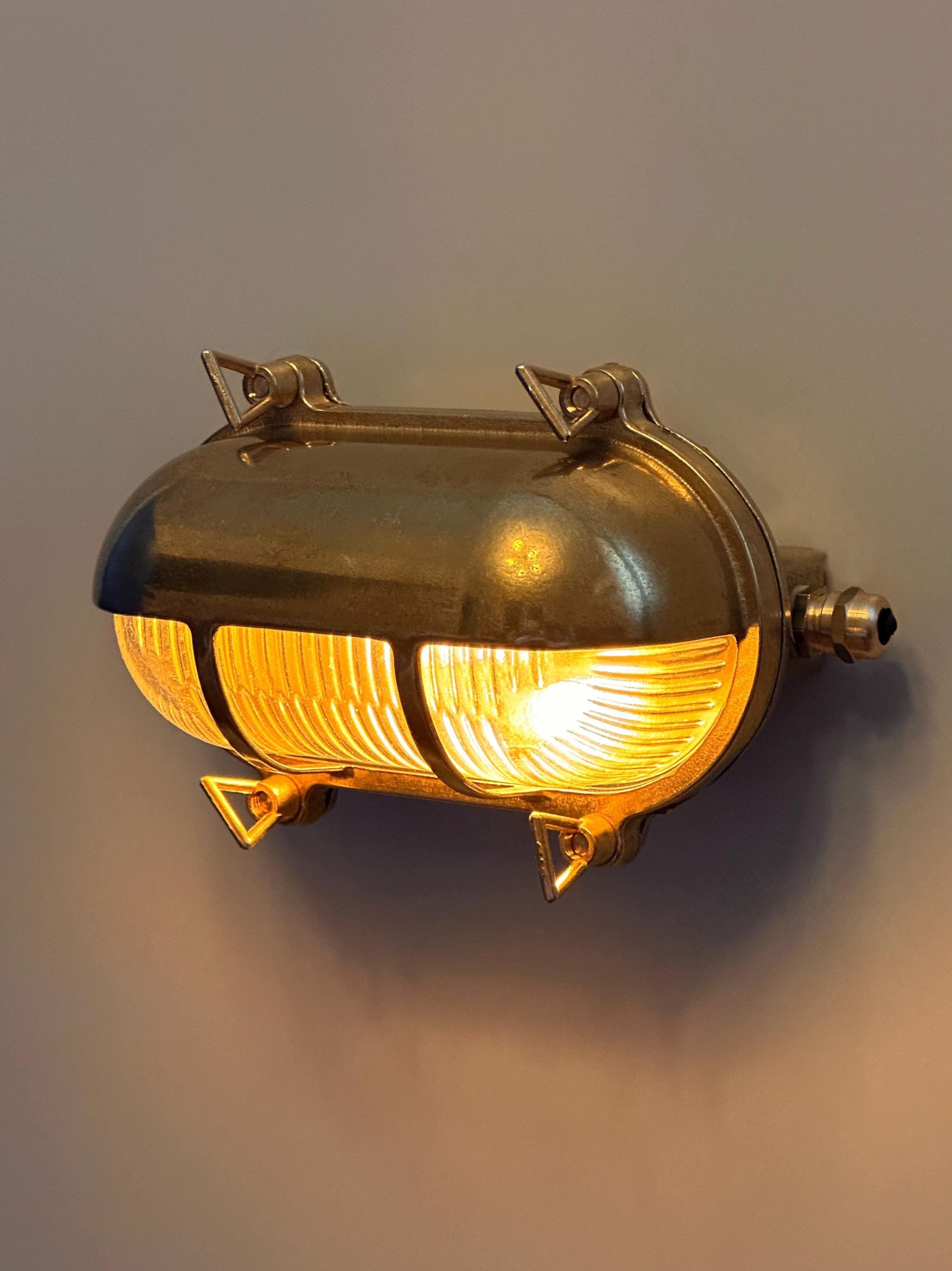 Gnarp Brass Outdoor Wall Sconce – Nautical Bulkhead Light with Ribbed Glass